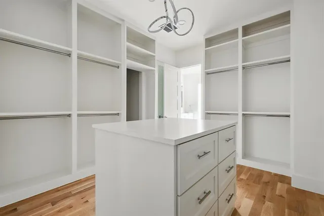 a kitchen with white cabinets and a window