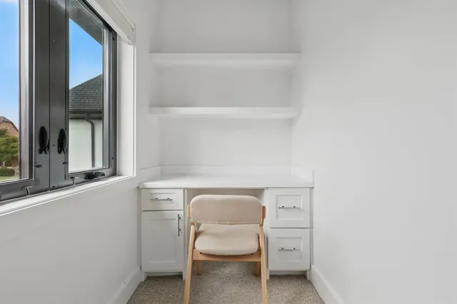 a utility room with a sink and a large mirror