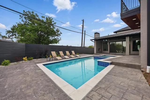 a view of a backyard with a tub and potted plants