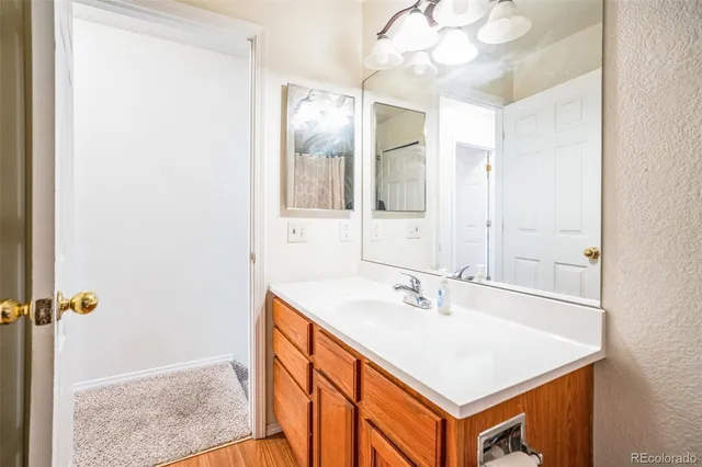 a bathroom with a sink a vanity and a mirror