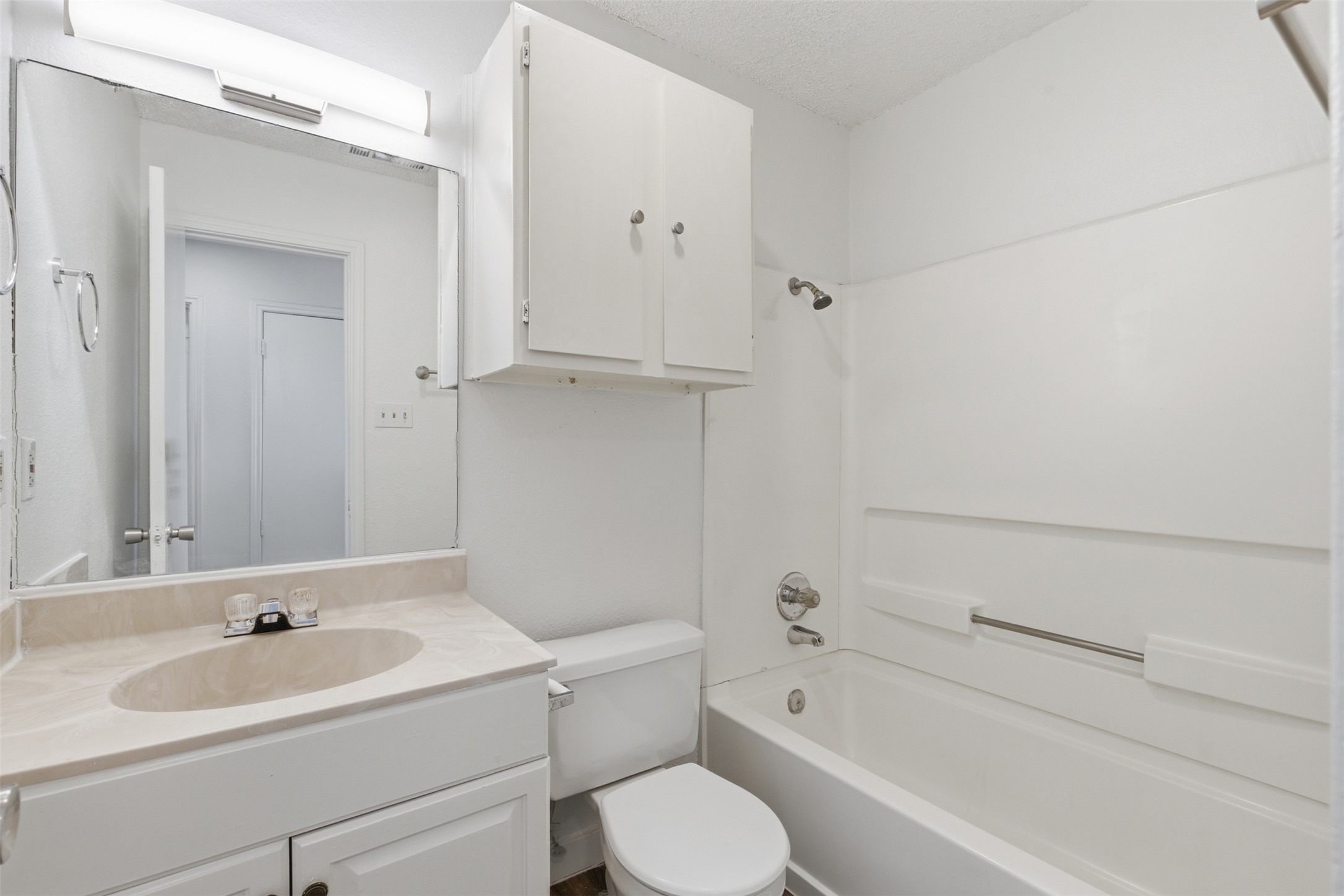 1605 Future Drive, Unit B Austin, TX 78754 - Photo 12 of 13 Bathroom with vanity, shower / washtub combination, and a textured ceiling