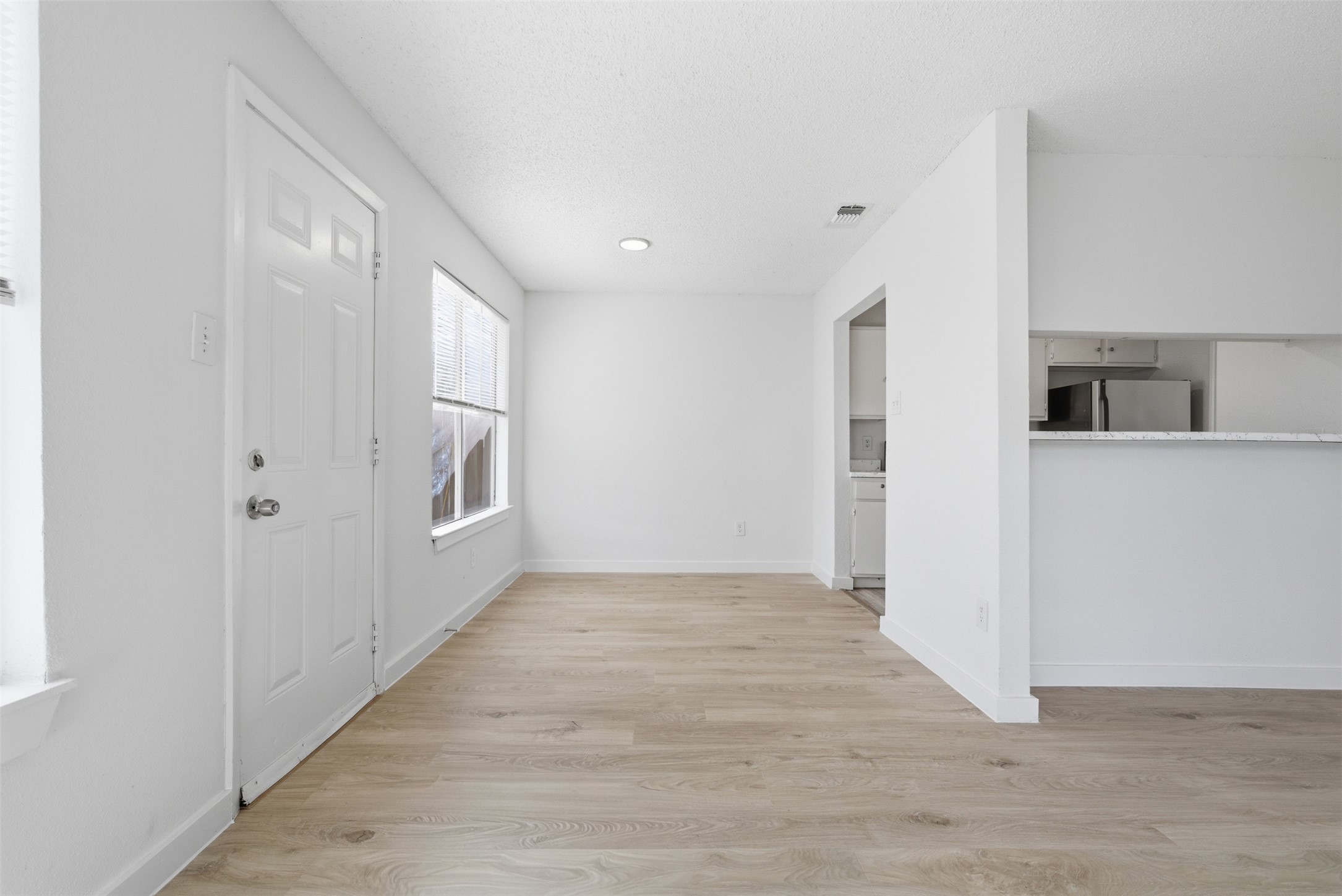 1605 Future Drive, Unit B Austin, TX 78754 - Photo 4 of 13 Dining area featuring light vinyl flooring and a textured ceiling