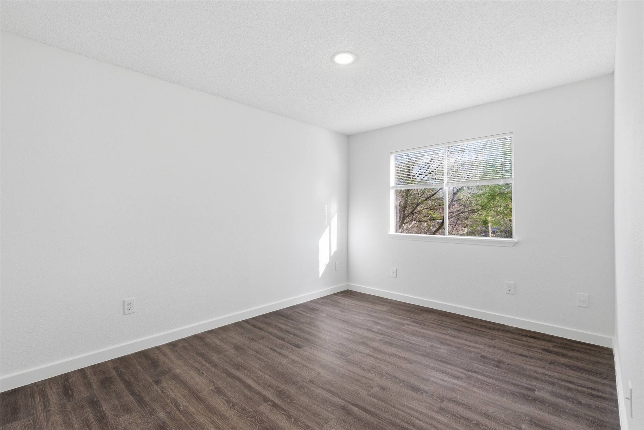 1605 Future Drive, Unit B Austin, TX 78754 - Photo 10 of 13 Bedroom with dark vinyl wood-style floors, a textured ceiling, and recessed lighting