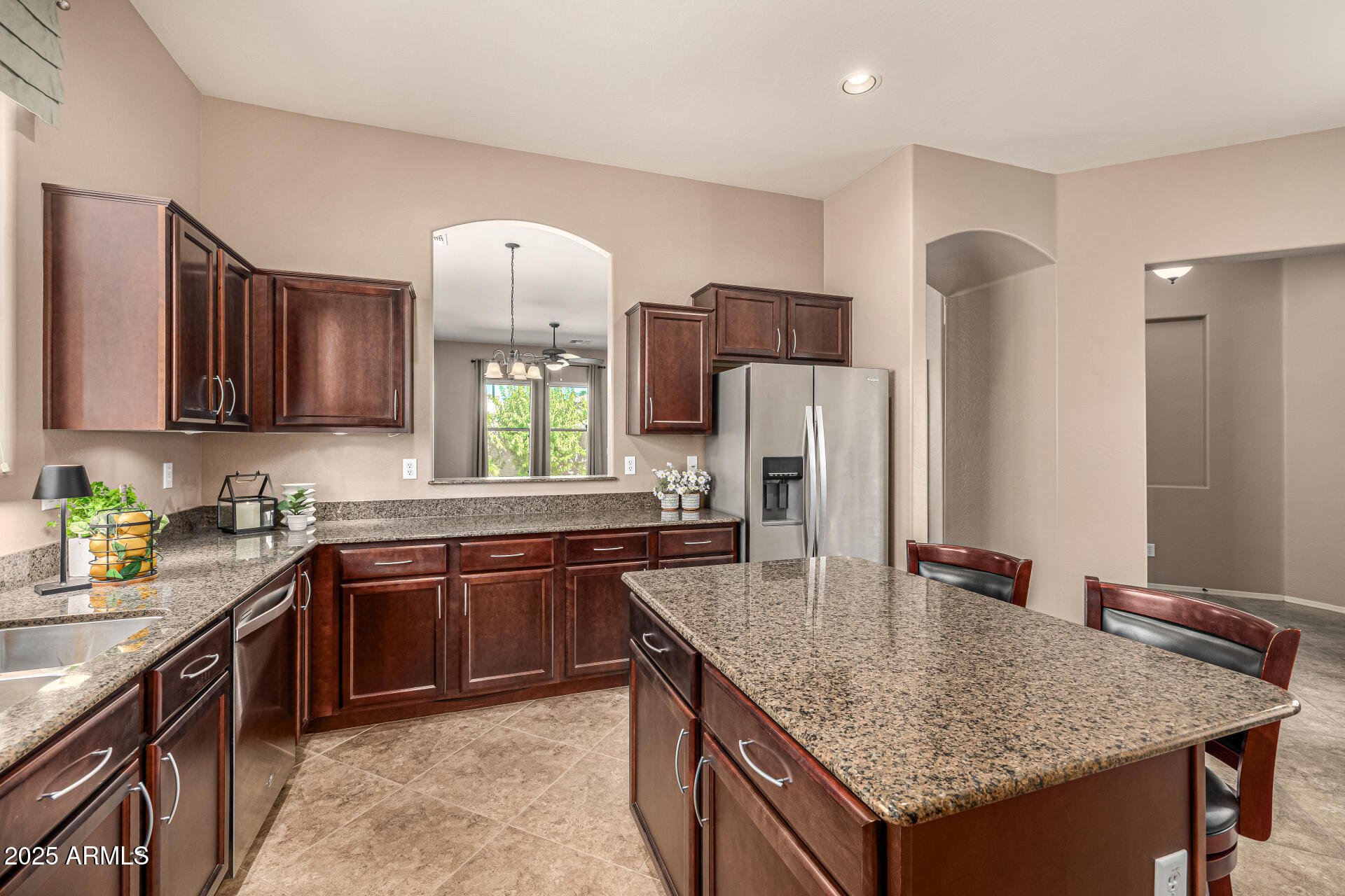 6202 East McKellips Road, Unit 156 Mesa, AZ 85215 - Photo 12 of 57 a kitchen with stainless steel appliances granite countertop a sink dishwasher stove and refrigerator