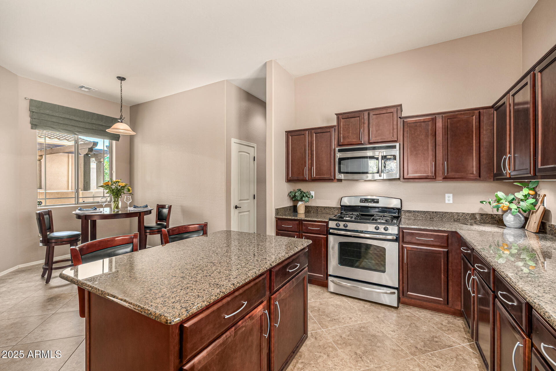 6202 East McKellips Road, Unit 156 Mesa, AZ 85215 - Photo 13 of 57 a kitchen with stainless steel appliances granite countertop a stove top oven a sink dishwasher and a refrigerator with wooden cabinets