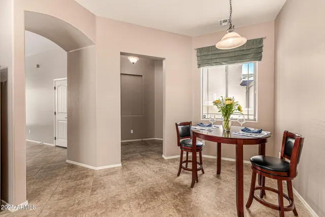 a dining room with furniture and window