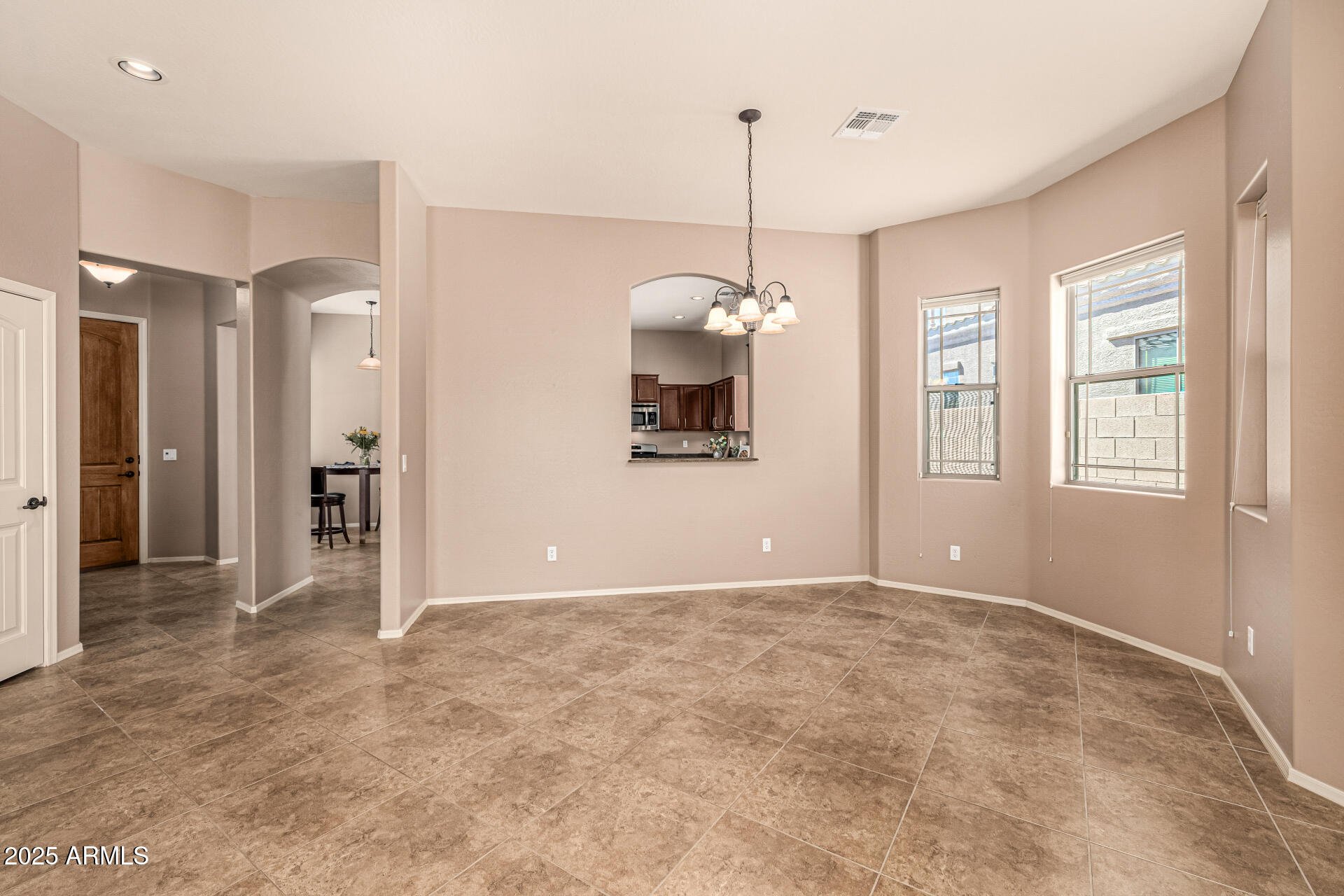 6202 East McKellips Road, Unit 156 Mesa, AZ 85215 - Photo 16 of 57 a view of an empty room with window and cabinet