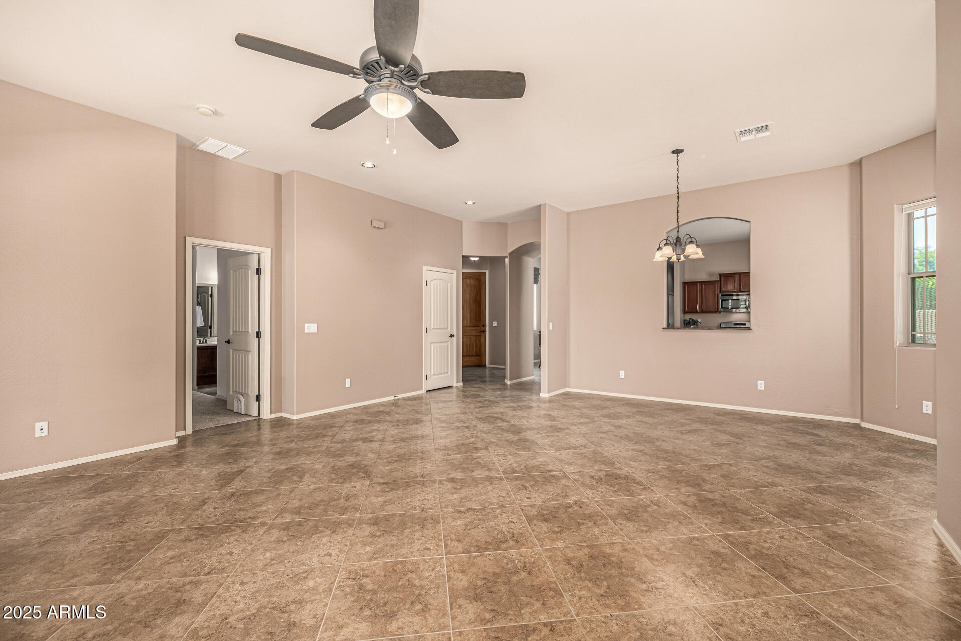 6202 East McKellips Road, Unit 156 Mesa, AZ 85215 - Photo 23 of 57 a view of an empty room with a ceiling fan