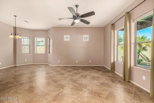 a view of a livingroom with a ceiling fan and window