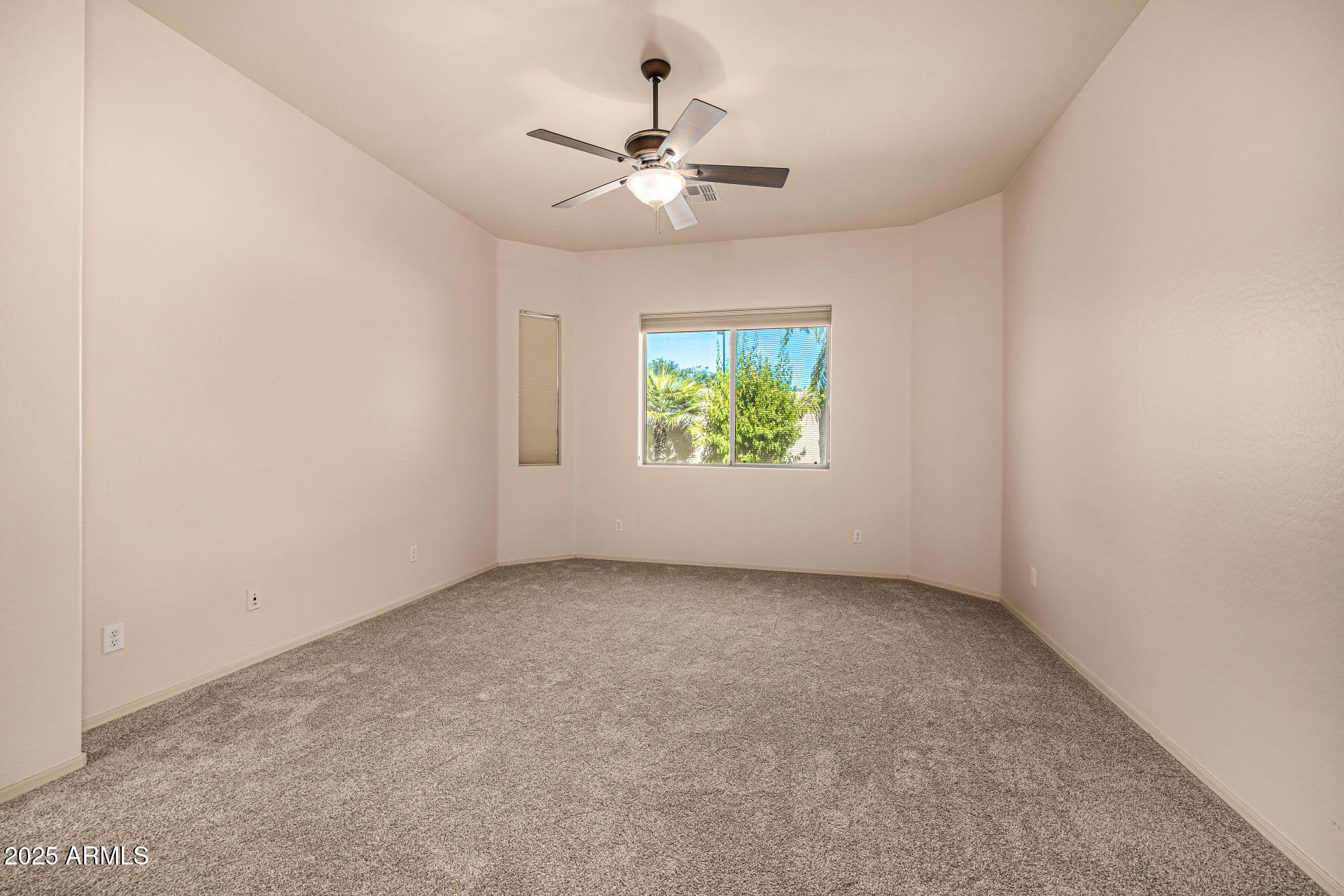 6202 East McKellips Road, Unit 156 Mesa, AZ 85215 - Photo 29 of 57 an empty room with windows and ceiling fan
