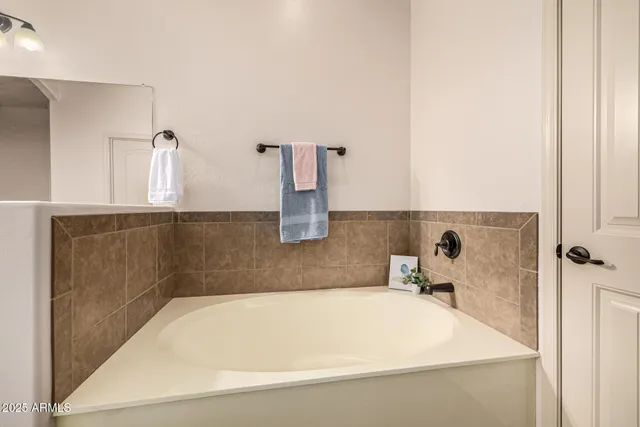 an empty room with fan and entrance