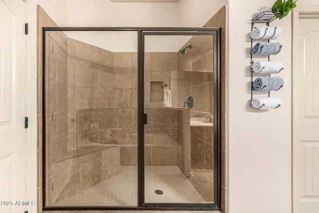 an empty room with windows and ceiling fan