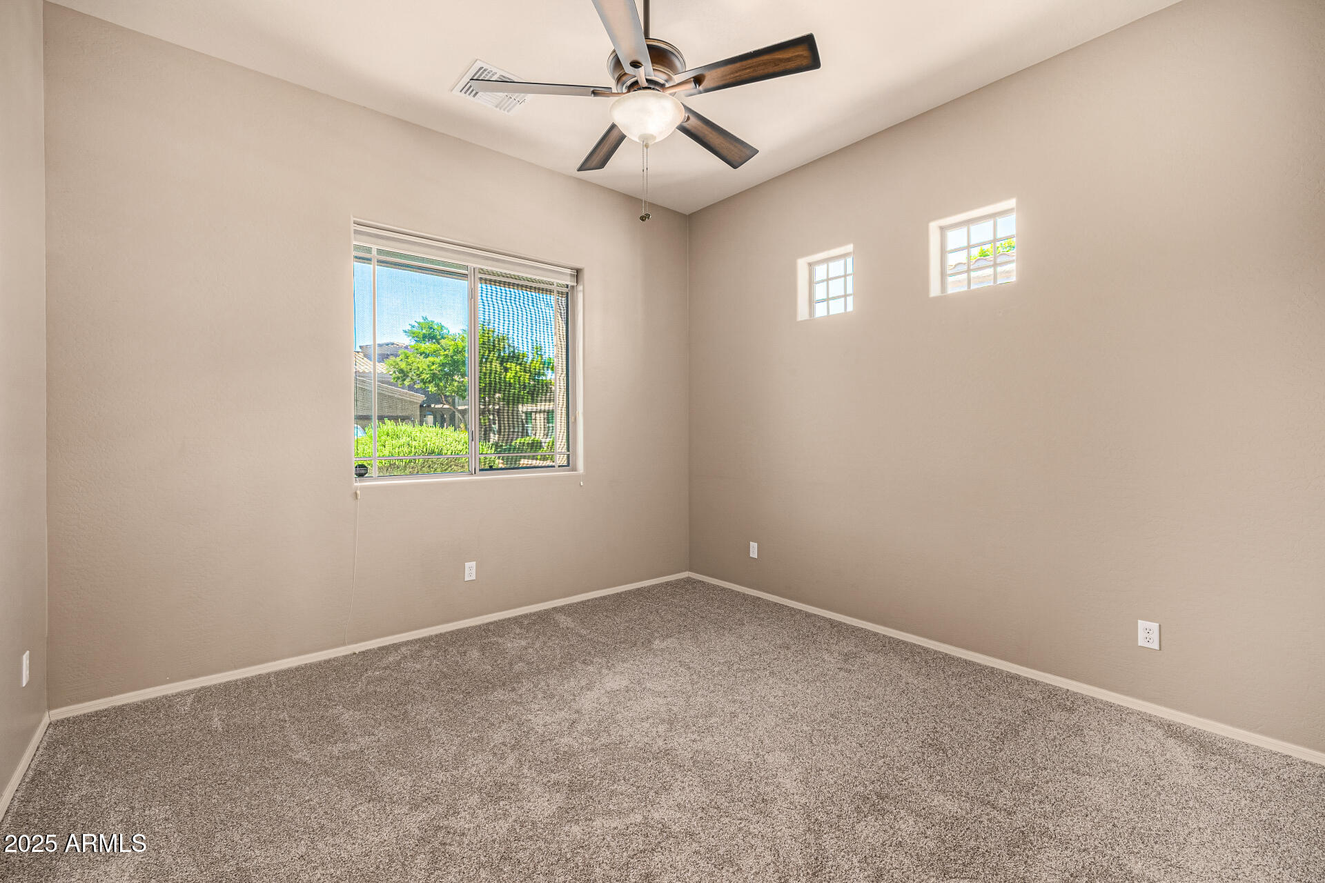 6202 East McKellips Road, Unit 156 Mesa, AZ 85215 - Photo 36 of 57 an empty room with windows and ceiling fan