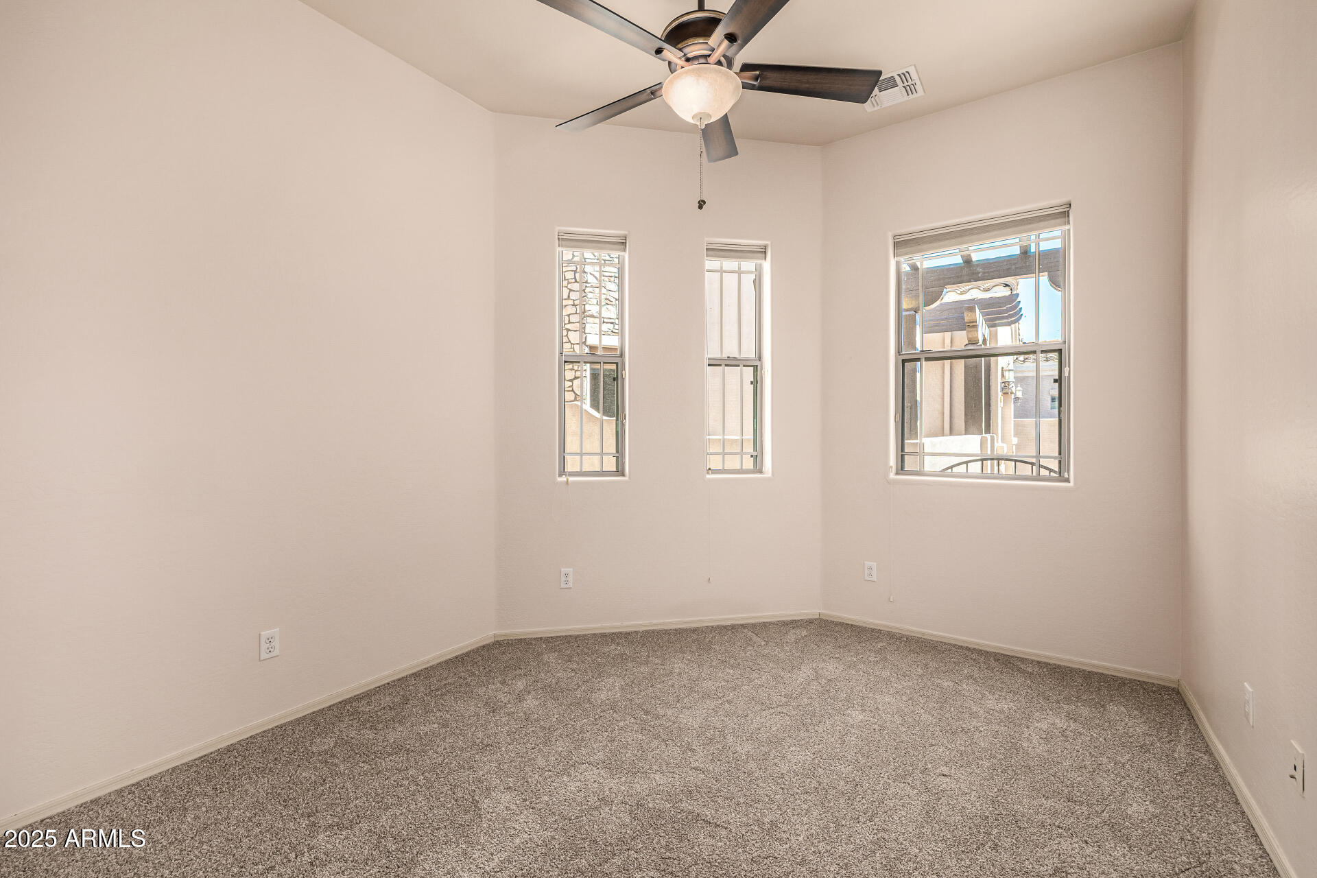 6202 East McKellips Road, Unit 156 Mesa, AZ 85215 - Photo 37 of 57 an empty room with windows and fan