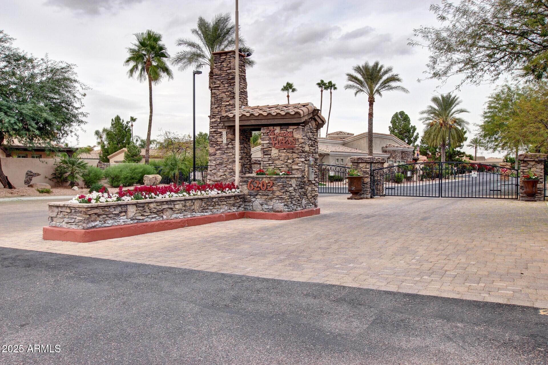 6202 East McKellips Road, Unit 156 Mesa, AZ 85215 - Photo 46 of 57 a row of palm trees and a fire pit with large trees