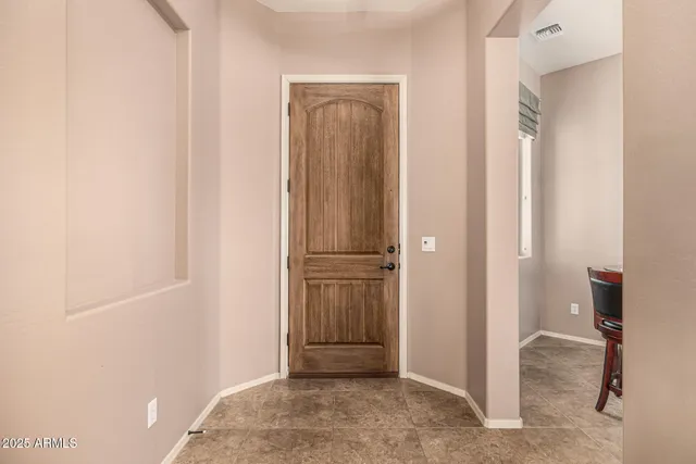 a kitchen with stainless steel appliances granite countertop a stove top oven a sink dishwasher a dining table and chairs