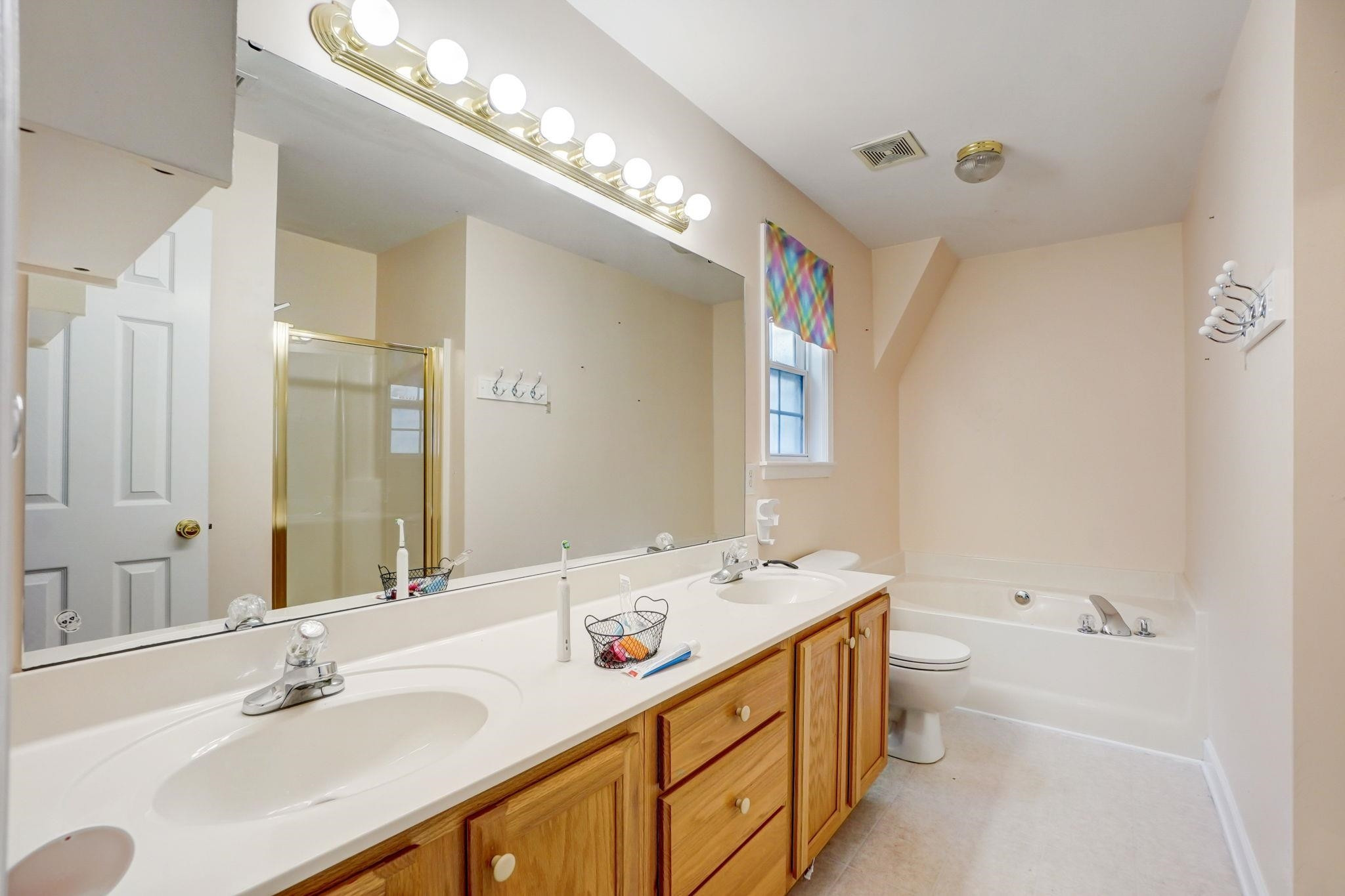 4816 Elmhurst Ridge Court Raleigh, NC 27616 - Photo 14 of 27 a bathroom with a sink double vanity and a mirror