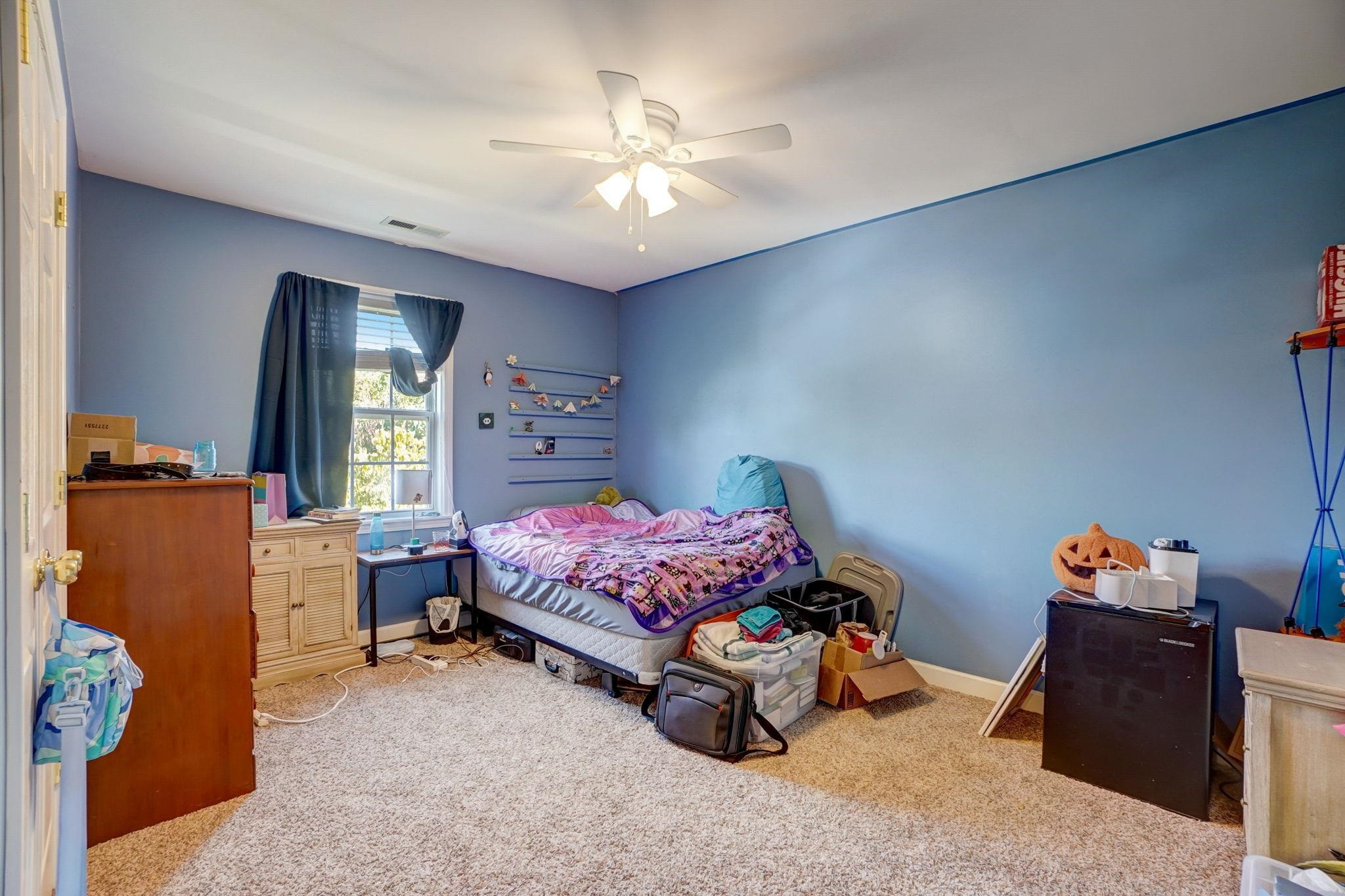 4816 Elmhurst Ridge Court Raleigh, NC 27616 - Photo 16 of 27 a bedroom with a bed and a chandelier