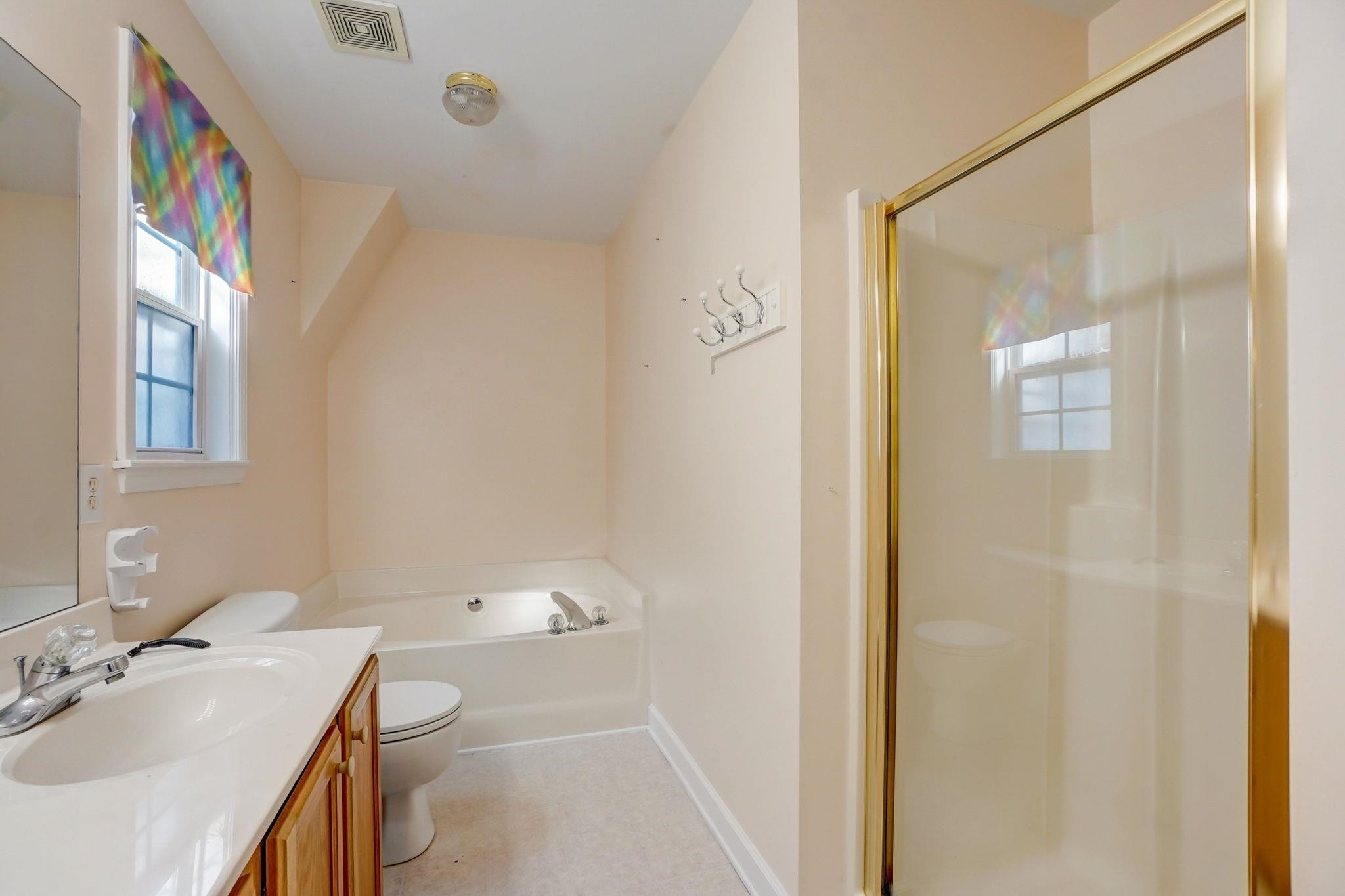 4816 Elmhurst Ridge Court Raleigh, NC 27616 - Photo 17 of 27 a bathroom with a sink a toilet and shower