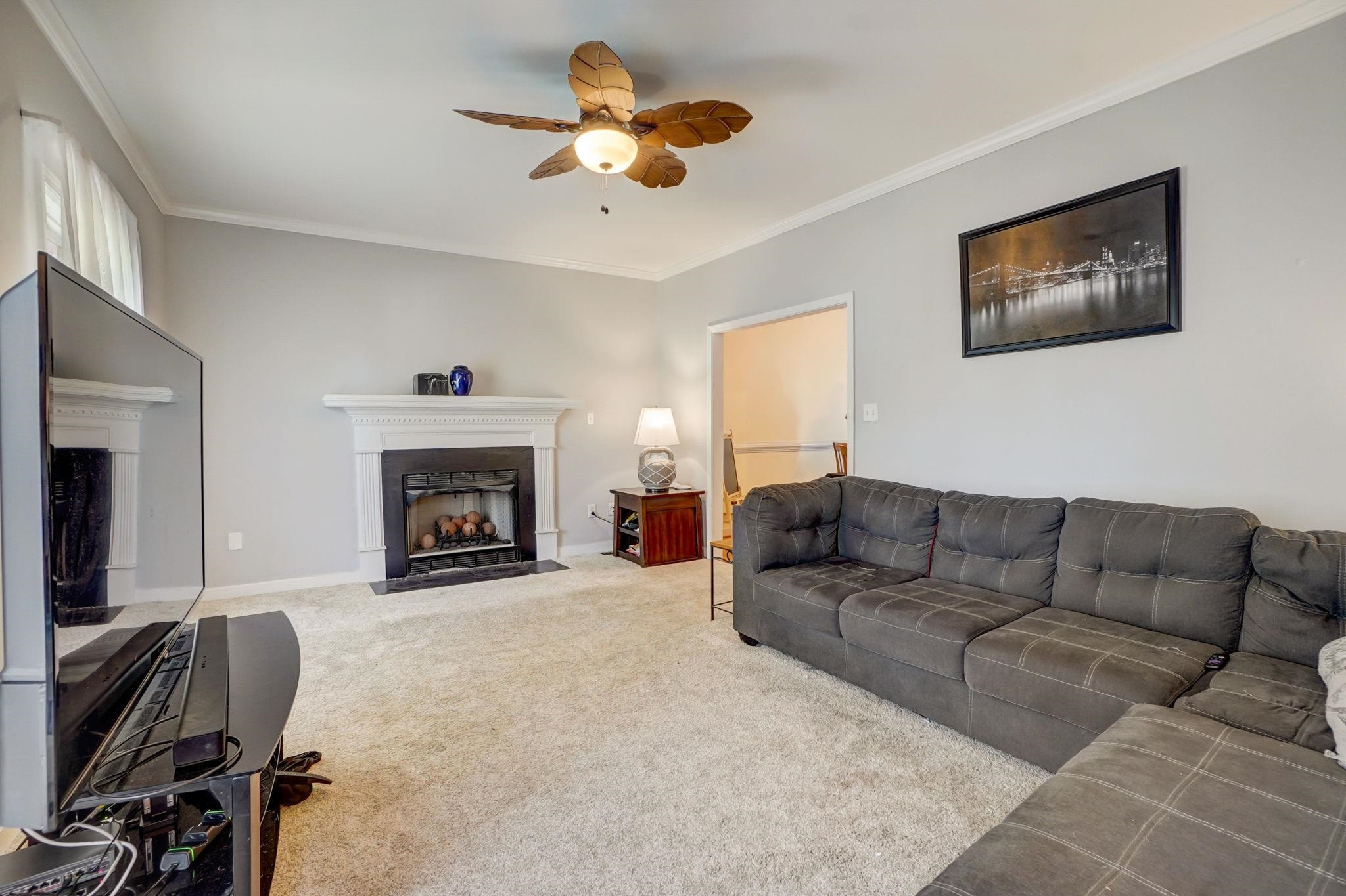 4816 Elmhurst Ridge Court Raleigh, NC 27616 - Photo 2 of 27 a living room with furniture and a fireplace