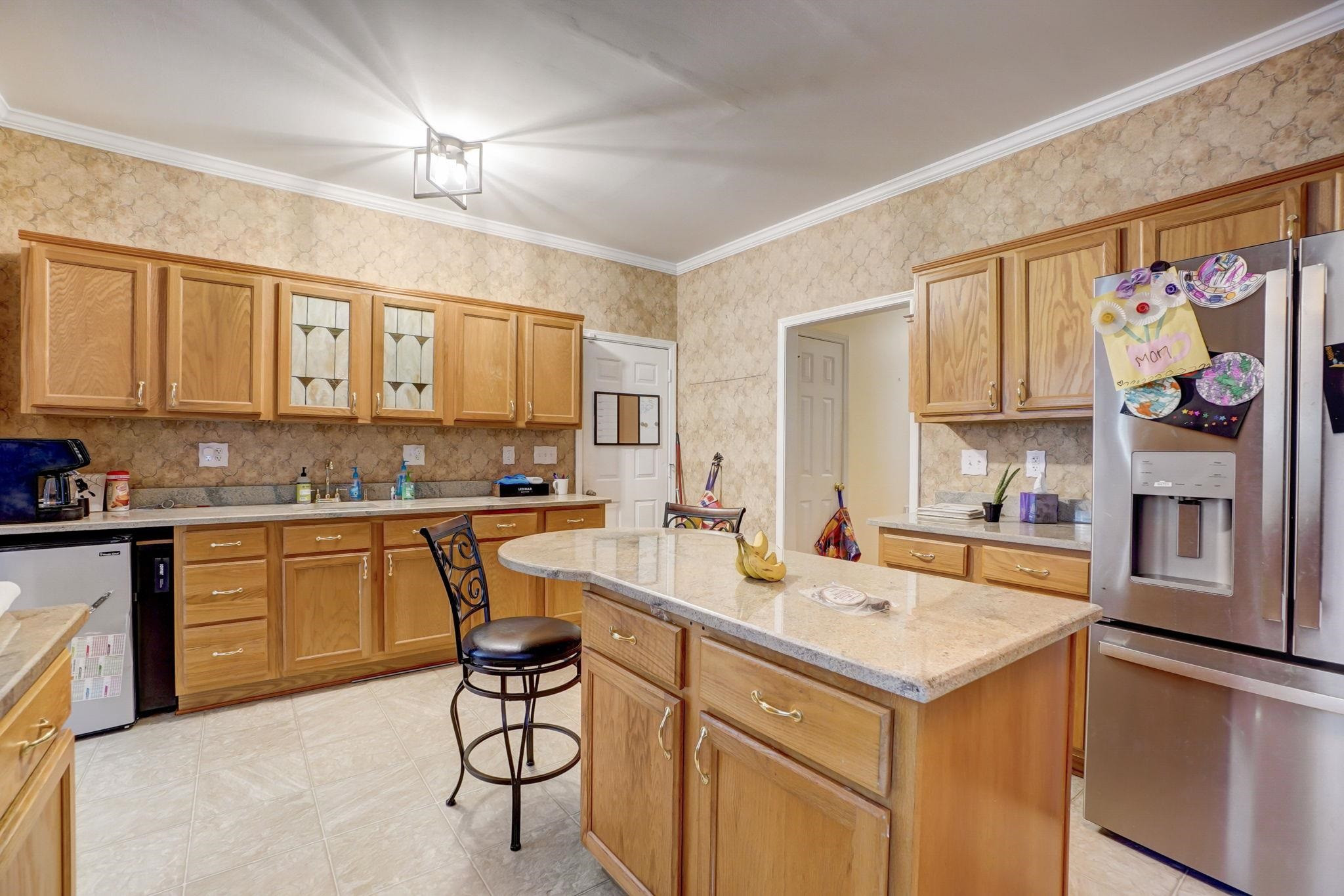 4816 Elmhurst Ridge Court Raleigh, NC 27616 - Photo 5 of 27 a kitchen with a sink refrigerator and cabinets