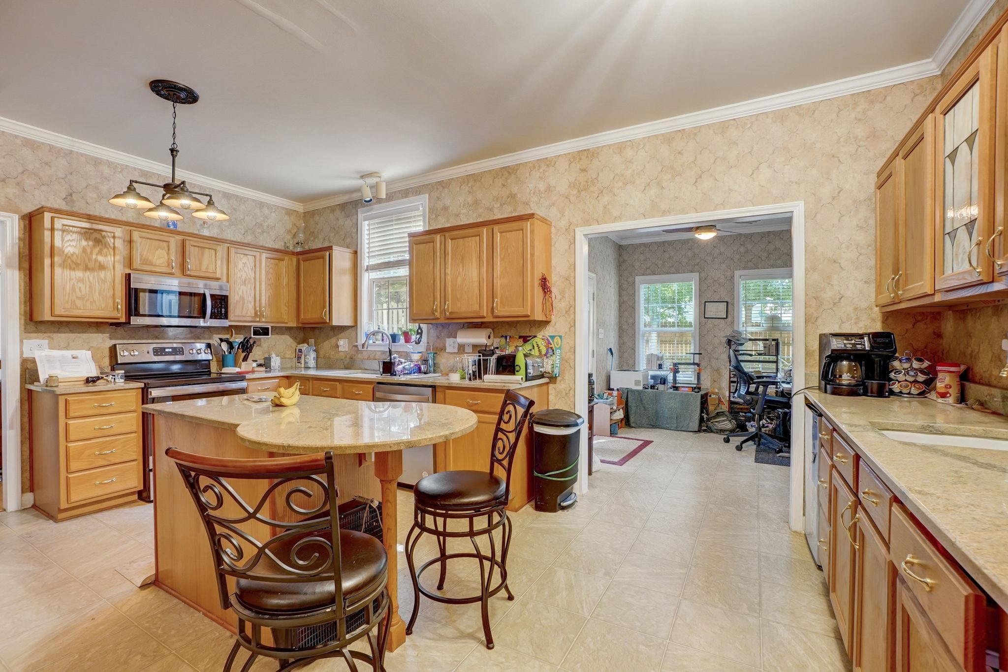4816 Elmhurst Ridge Court Raleigh, NC 27616 - Photo 7 of 27 a large kitchen with a table and chairs