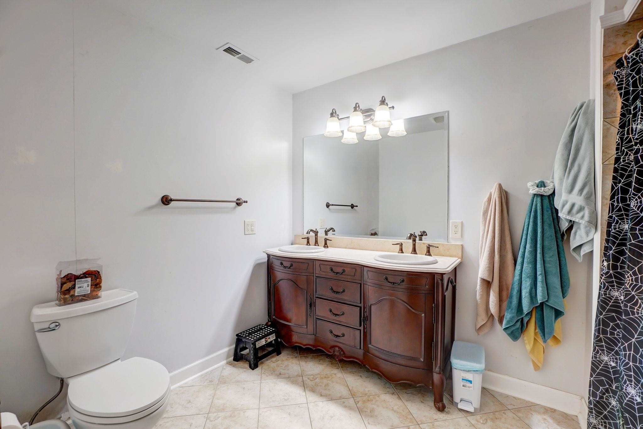 4816 Elmhurst Ridge Court Raleigh, NC 27616 - Photo 8 of 27 a spacious bathroom with a double vanity sink and a mirror