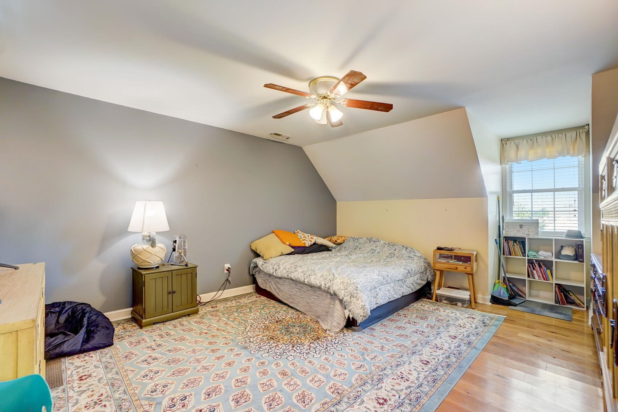 4816 Elmhurst Ridge Court Raleigh, NC 27616 - Photo 9 of 27 a bedroom with a bed and wooden floor