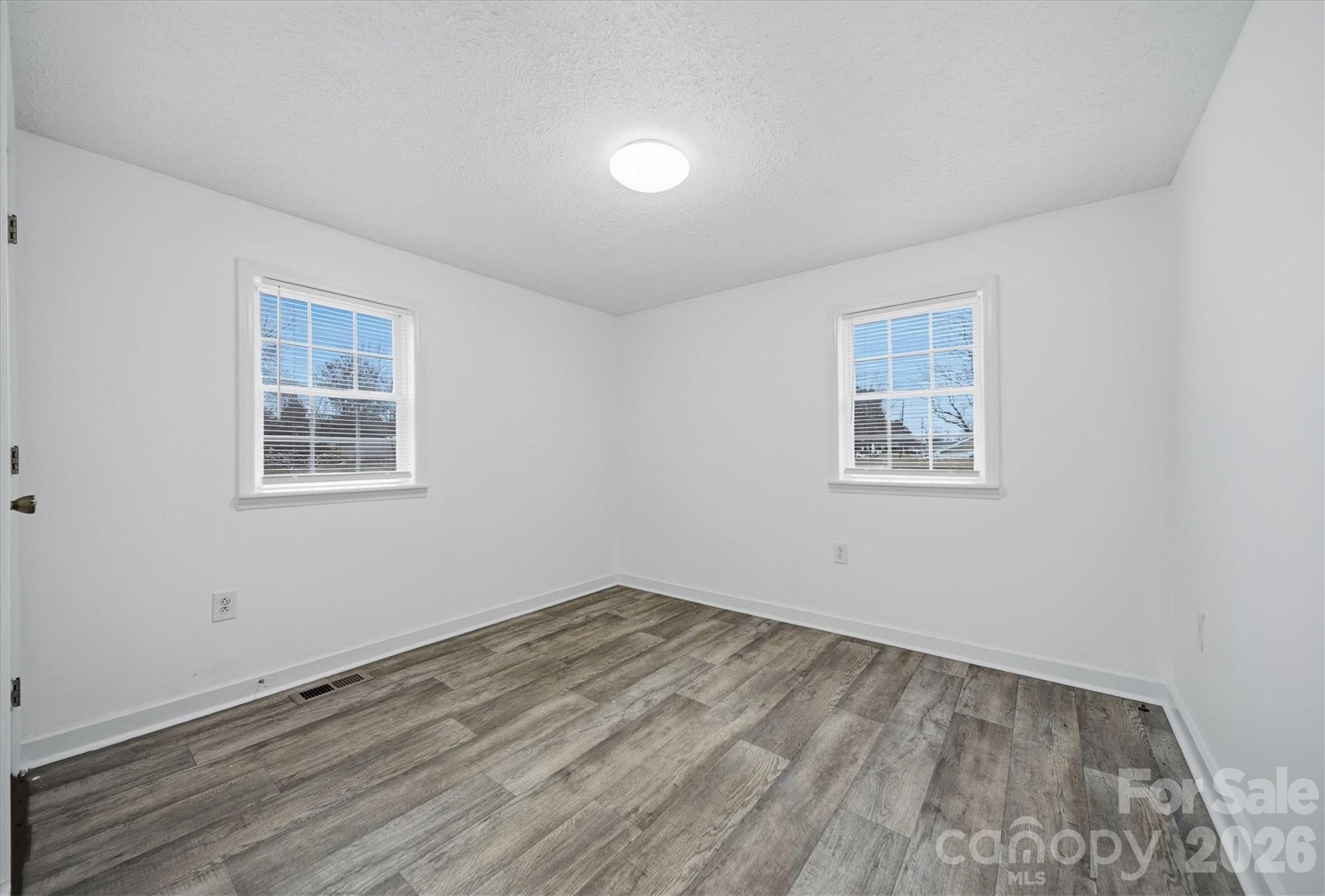 316 23rd Street Northwest Hickory, NC 28601 - Photo 11 of 15 a view of empty room with wooden floor and fan