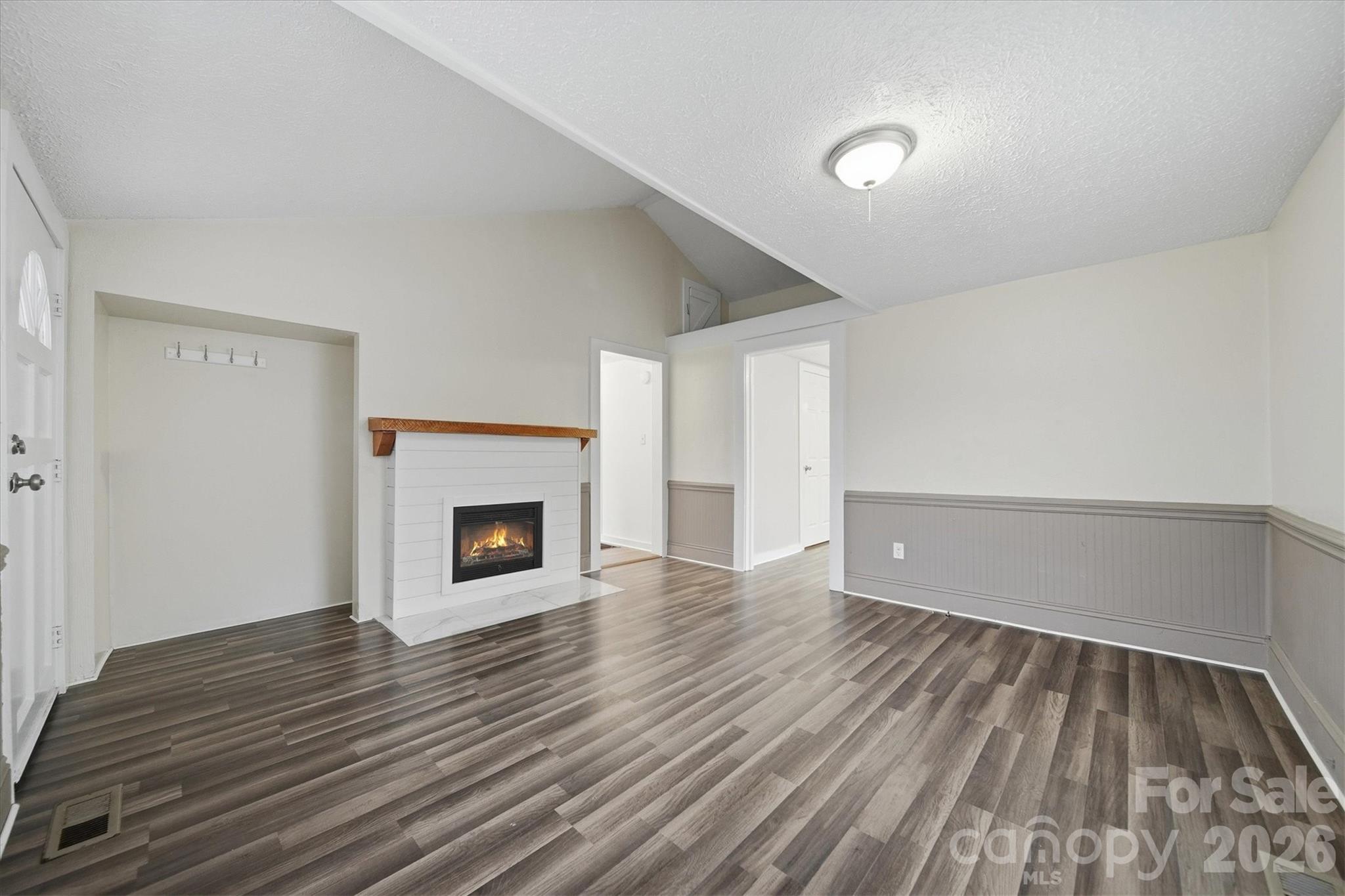 316 23rd Street Northwest Hickory, NC 28601 - Photo 3 of 15 a view of a livingroom with wooden floor and a fireplace