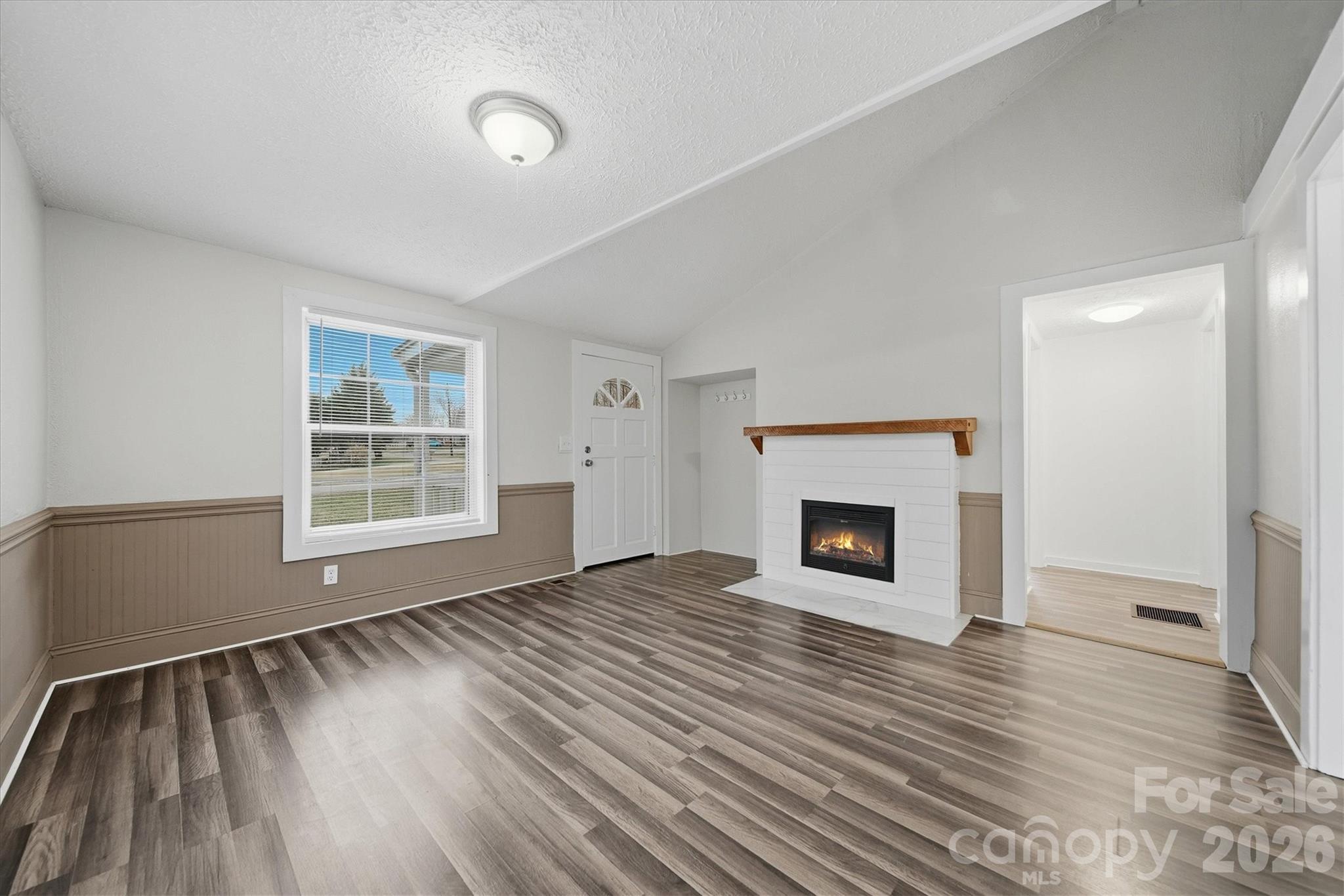 316 23rd Street Northwest Hickory, NC 28601 - Photo 4 of 15 a view of an empty room with wooden floor fireplace and a window