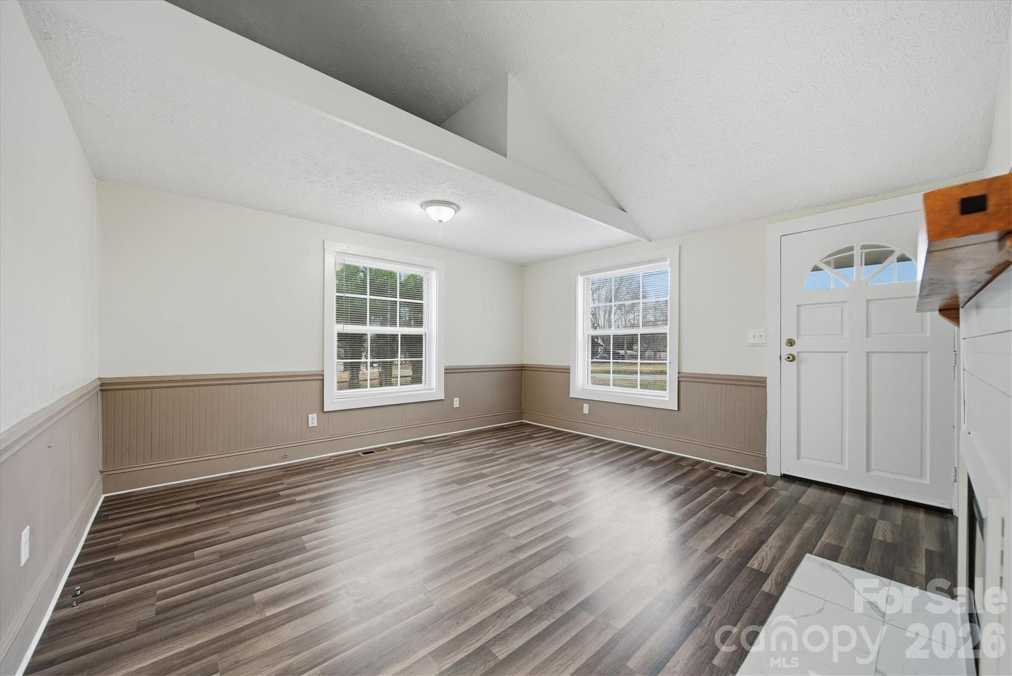 316 23rd Street Northwest Hickory, NC 28601 - Photo 5 of 15 a view of an empty room with wooden floor and a window