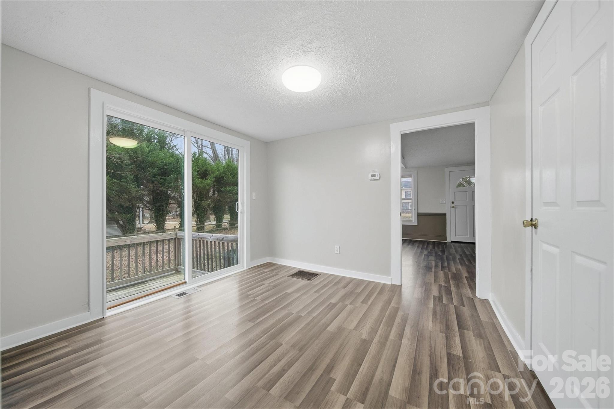 316 23rd Street Northwest Hickory, NC 28601 - Photo 7 of 15 an empty room with wooden floor and windows