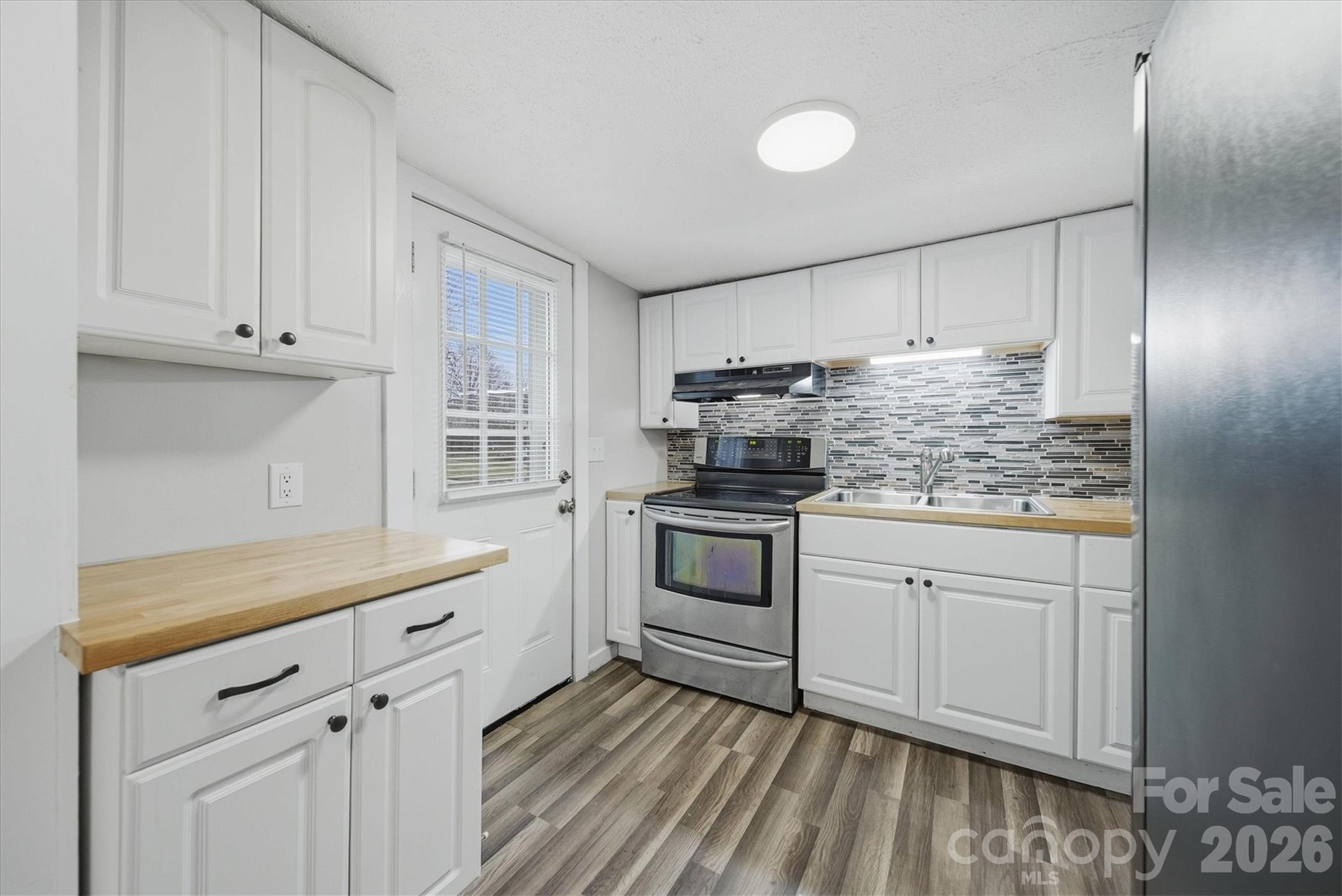 316 23rd Street Northwest Hickory, NC 28601 - Photo 8 of 15 a kitchen with granite countertop white cabinets and white appliances