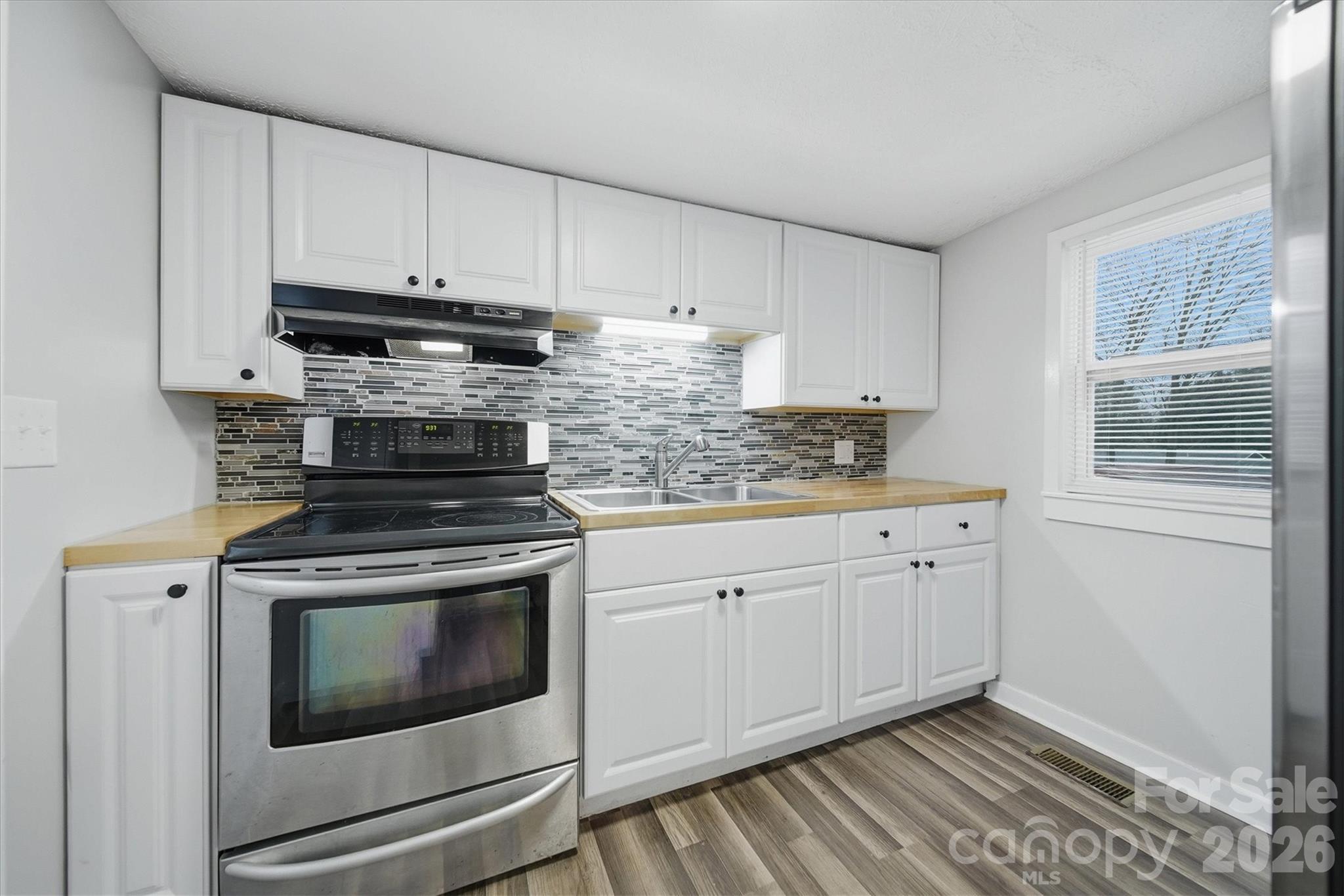 316 23rd Street Northwest Hickory, NC 28601 - Photo 9 of 15 a kitchen with granite countertop white cabinets and white appliances