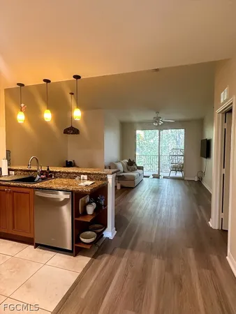 a view of a kitchen with a sink and wooden floor