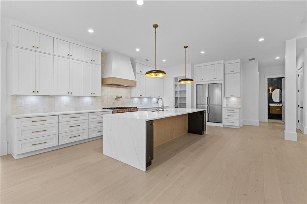 2865 Old Fountain Road Dacula, GA 30019 - Photo 18 of 84 a kitchen with kitchen island cabinets and stainless steel appliances