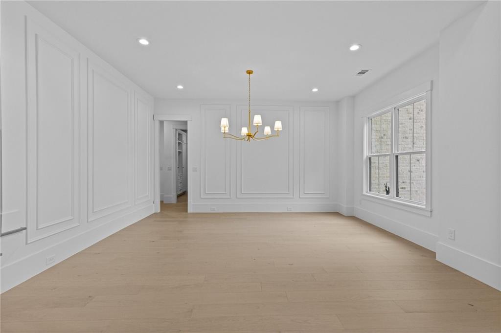 2865 Old Fountain Road Dacula, GA 30019 - Photo 20 of 84 an empty room with chandelier fan and windows