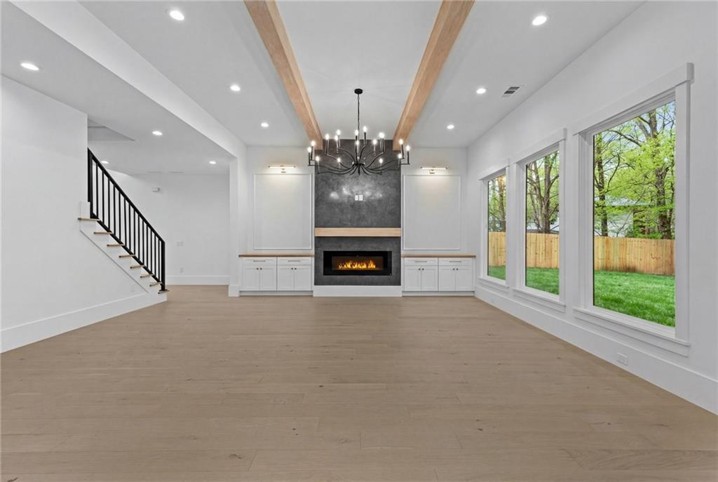 2865 Old Fountain Road Dacula, GA 30019 - Photo 24 of 84 a view of an empty room with a fireplace and a large window