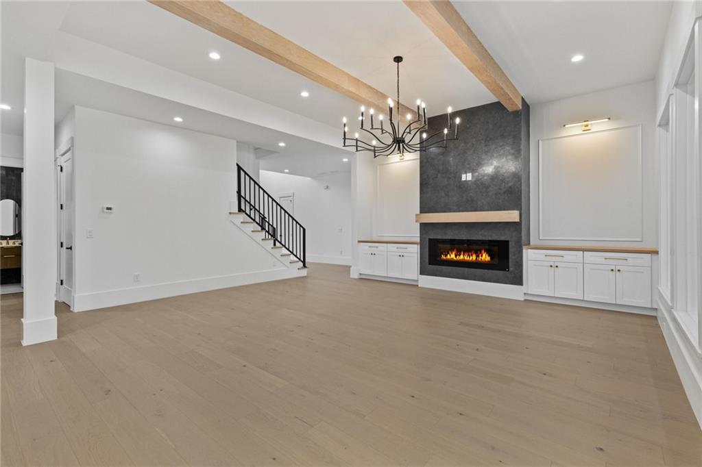 2865 Old Fountain Road Dacula, GA 30019 - Photo 25 of 84 a view of a livingroom with a fireplace a chandelier and entryway
