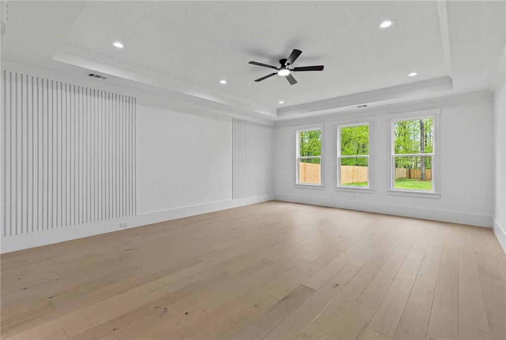 2865 Old Fountain Road Dacula, GA 30019 - Photo 33 of 84 an empty room with windows ceiling fan and windows