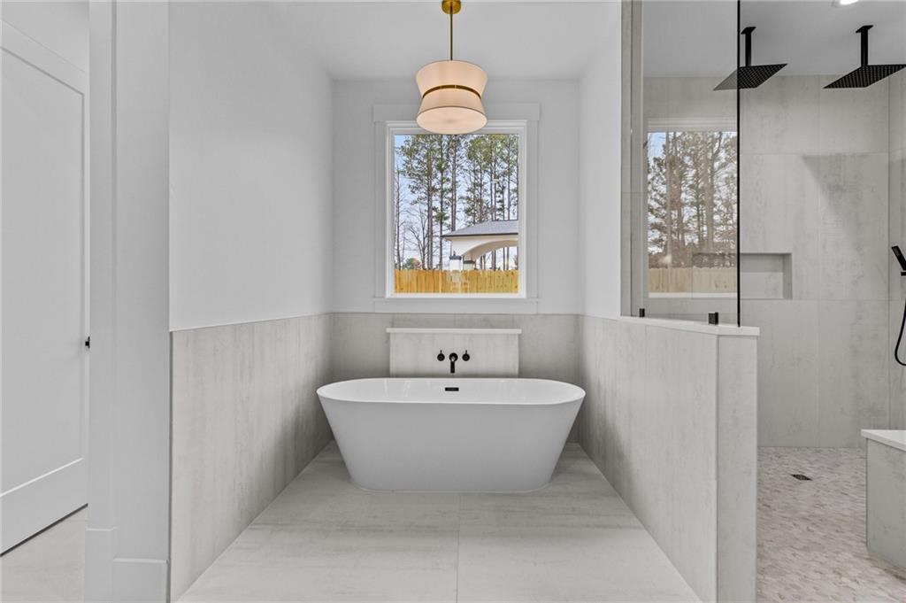 2865 Old Fountain Road Dacula, GA 30019 - Photo 39 of 84 a bathroom with a bathtub and sink