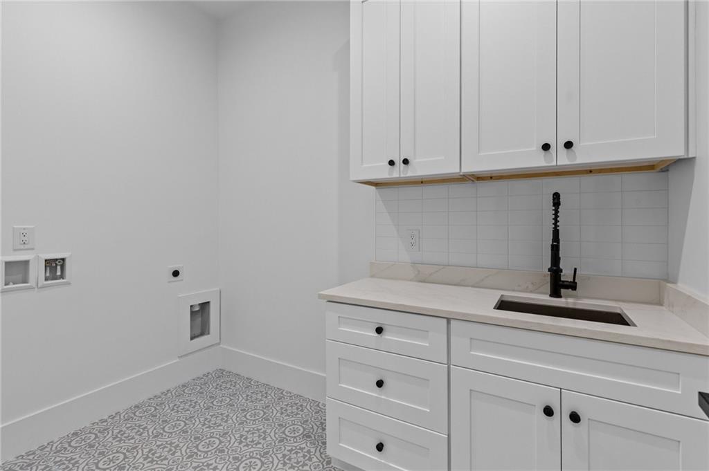 2865 Old Fountain Road Dacula, GA 30019 - Photo 47 of 84 a kitchen with white cabinets and a sink