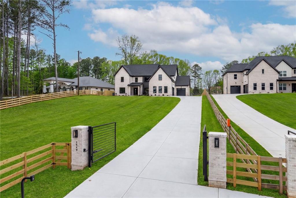 2865 Old Fountain Road Dacula, GA 30019 - Photo 5 of 84 a front view of a house with a yard