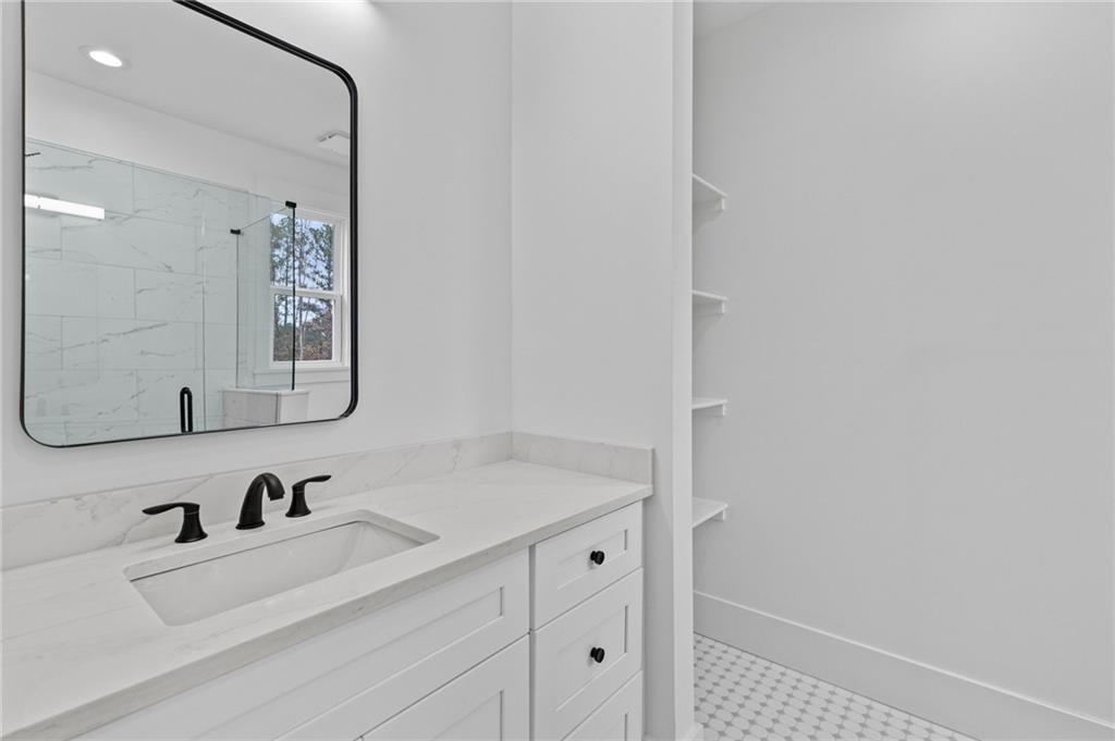 2865 Old Fountain Road Dacula, GA 30019 - Photo 57 of 84 a bathroom with a sink vanity and a mirror