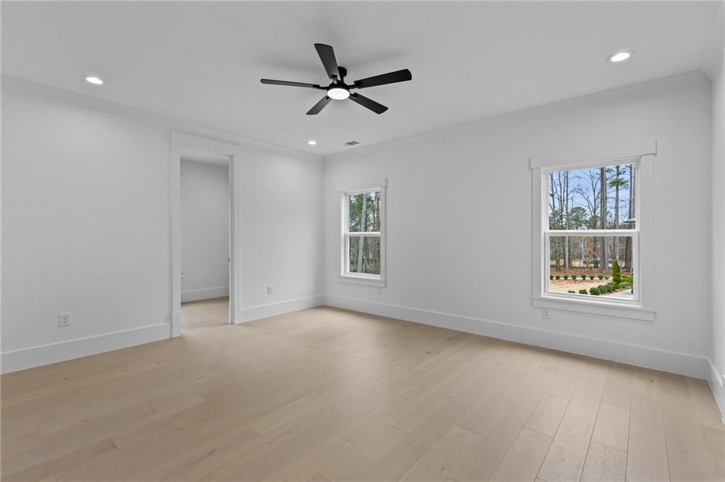 2865 Old Fountain Road Dacula, GA 30019 - Photo 60 of 84 an empty room with a window and a ceiling fan