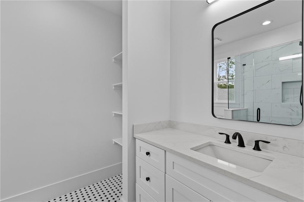 2865 Old Fountain Road Dacula, GA 30019 - Photo 63 of 84 a bathroom with a sink vanity and a mirror