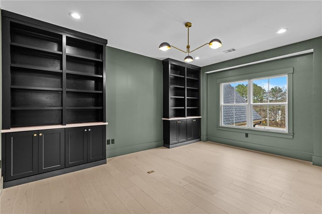 2865 Old Fountain Road Dacula, GA 30019 - Photo 65 of 84 a view of an empty room with a window and a bookshelf