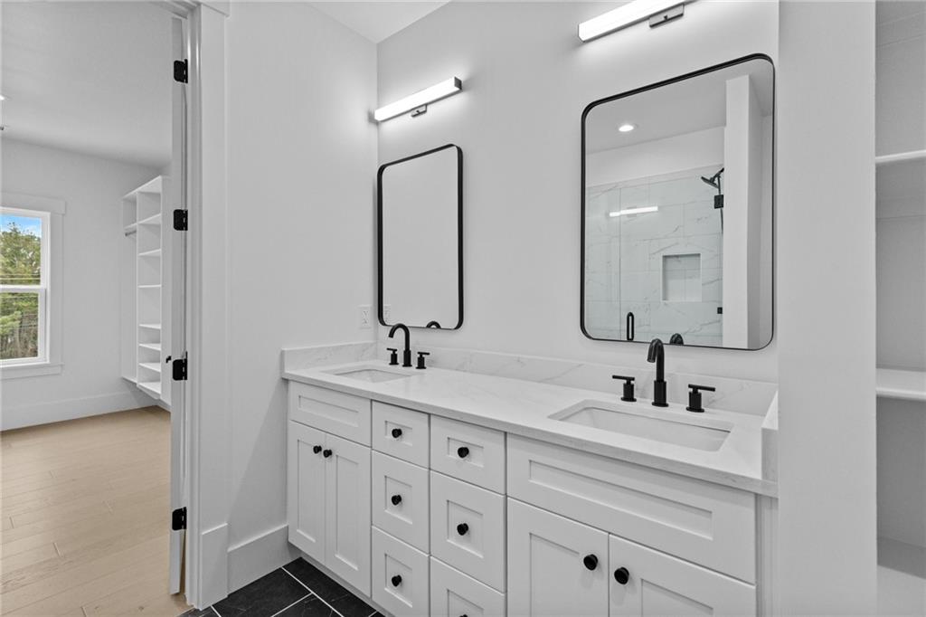2865 Old Fountain Road Dacula, GA 30019 - Photo 73 of 84 a bathroom with double sink and a mirror