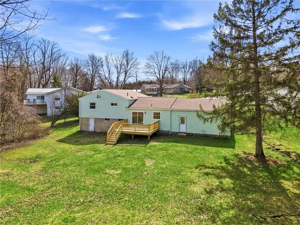 a view of a house with backyard and deck